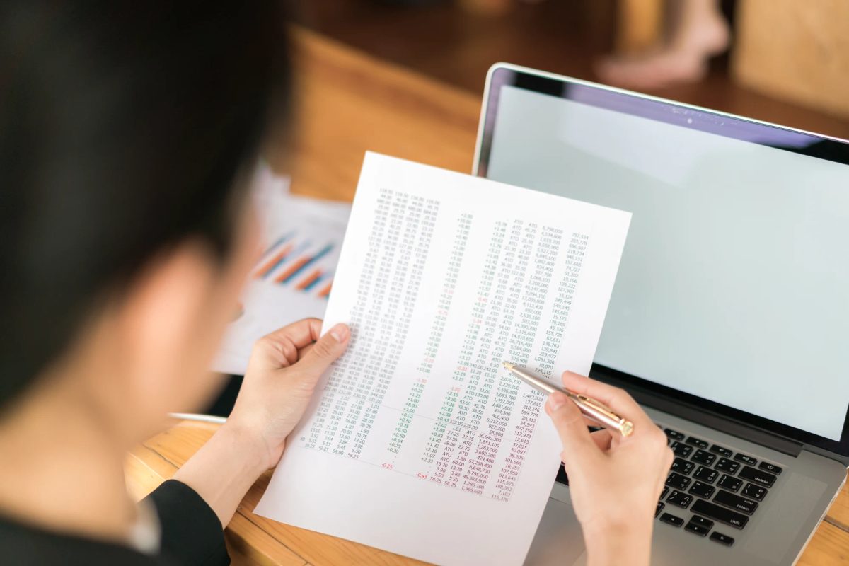 Business registration document sitting next to a stack of handwritten order receipts